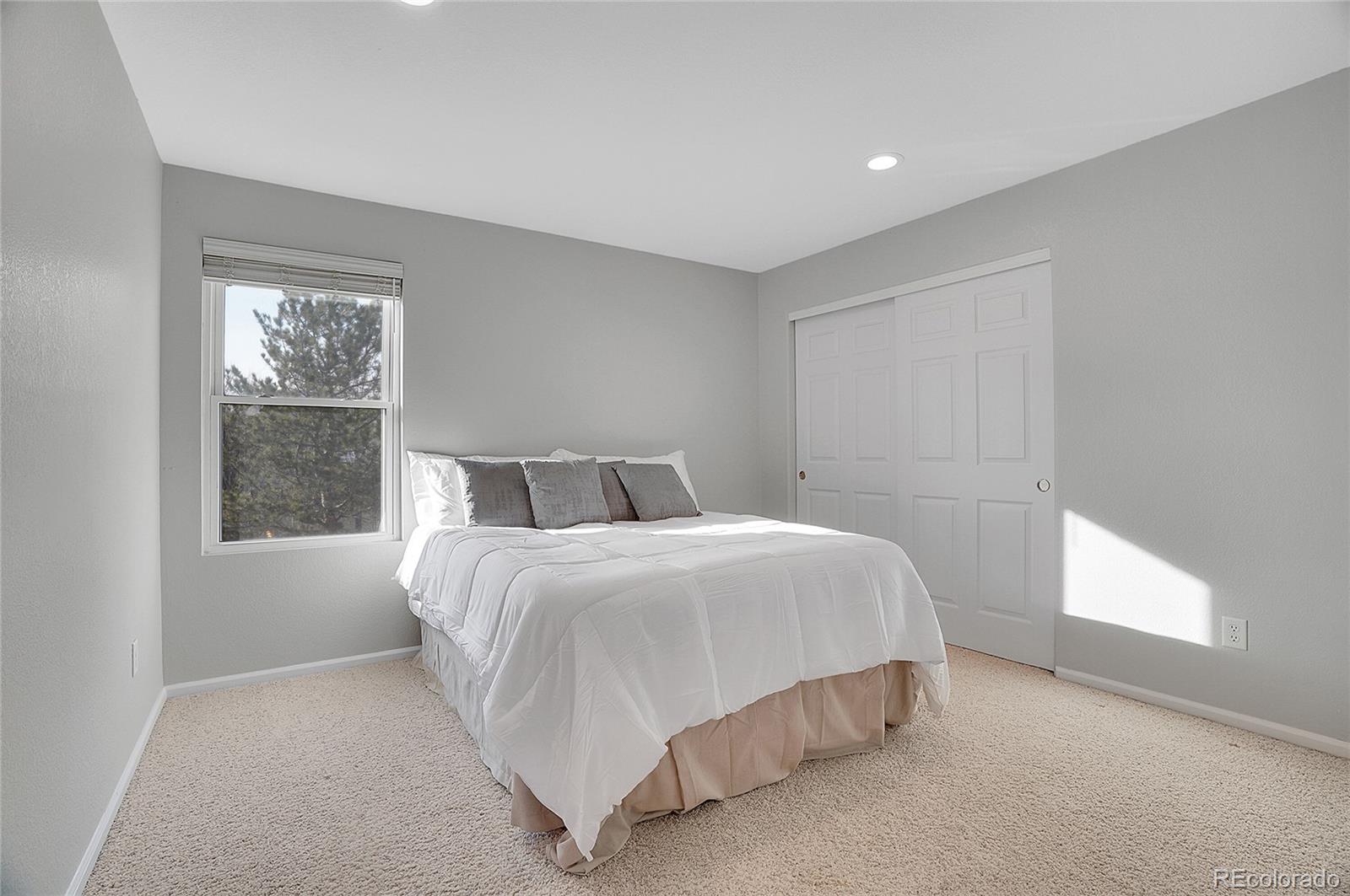 6348 Westview Circle Parker, CO 80134 - Photo 17 of 27 a spacious bedroom with a bed and window
