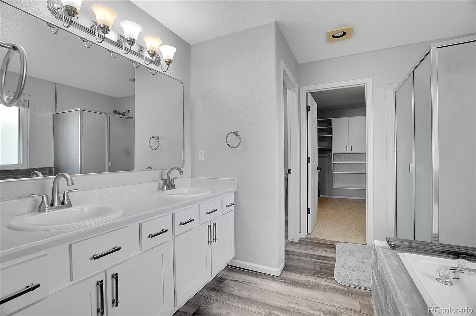 6348 Westview Circle Parker, CO 80134 - Photo 18 of 27 a bathroom with double vanity sinks and a mirror