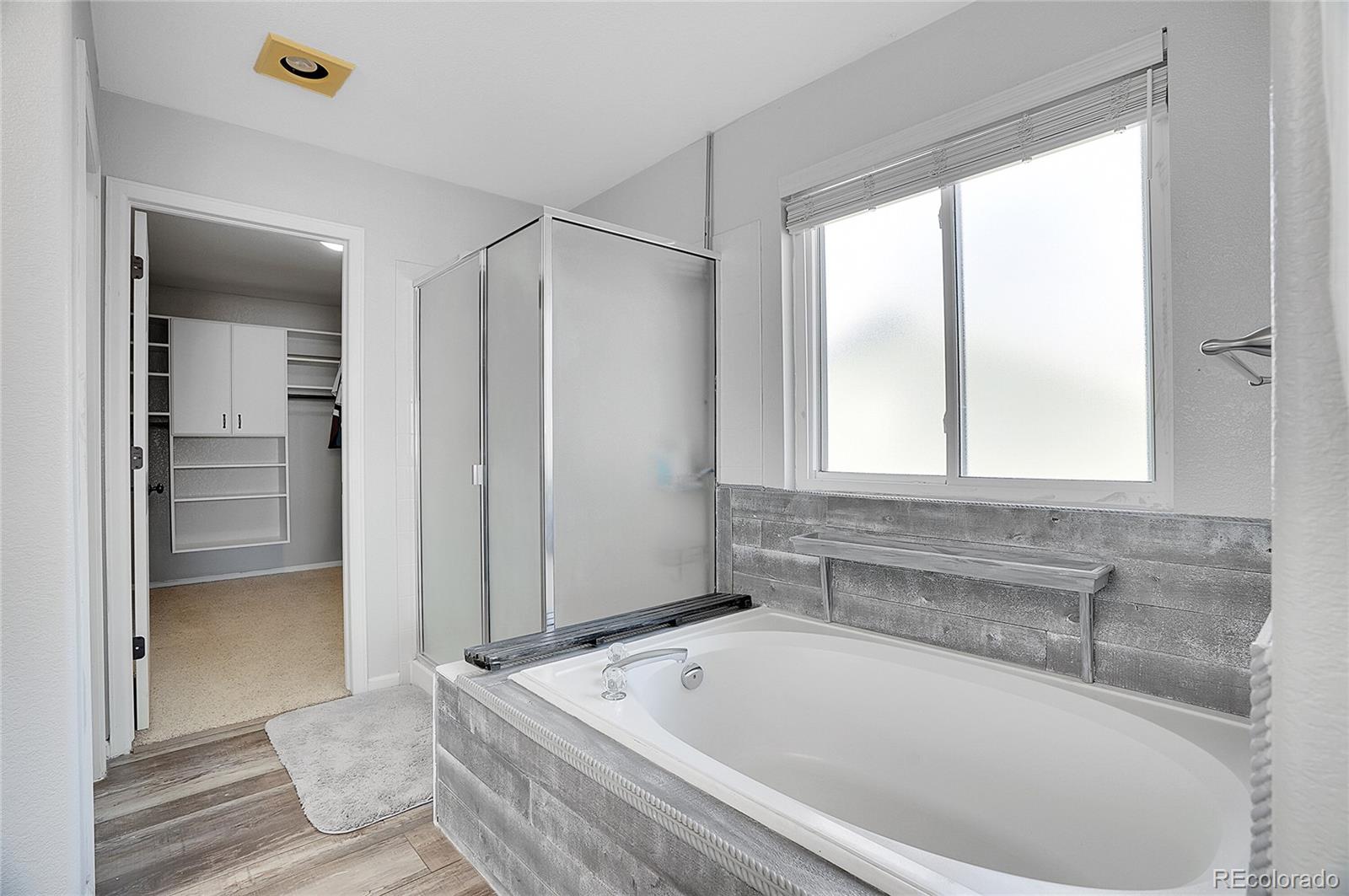 6348 Westview Circle Parker, CO 80134 - Photo 19 of 27 a bathroom with a tub a sink and a window