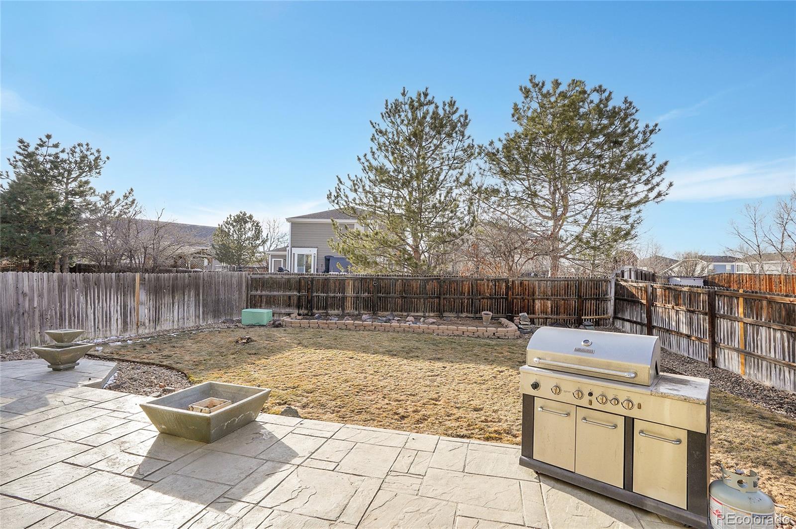 6348 Westview Circle Parker, CO 80134 - Photo 26 of 27 a view of a patio with a dining table and chairs with wooden fence