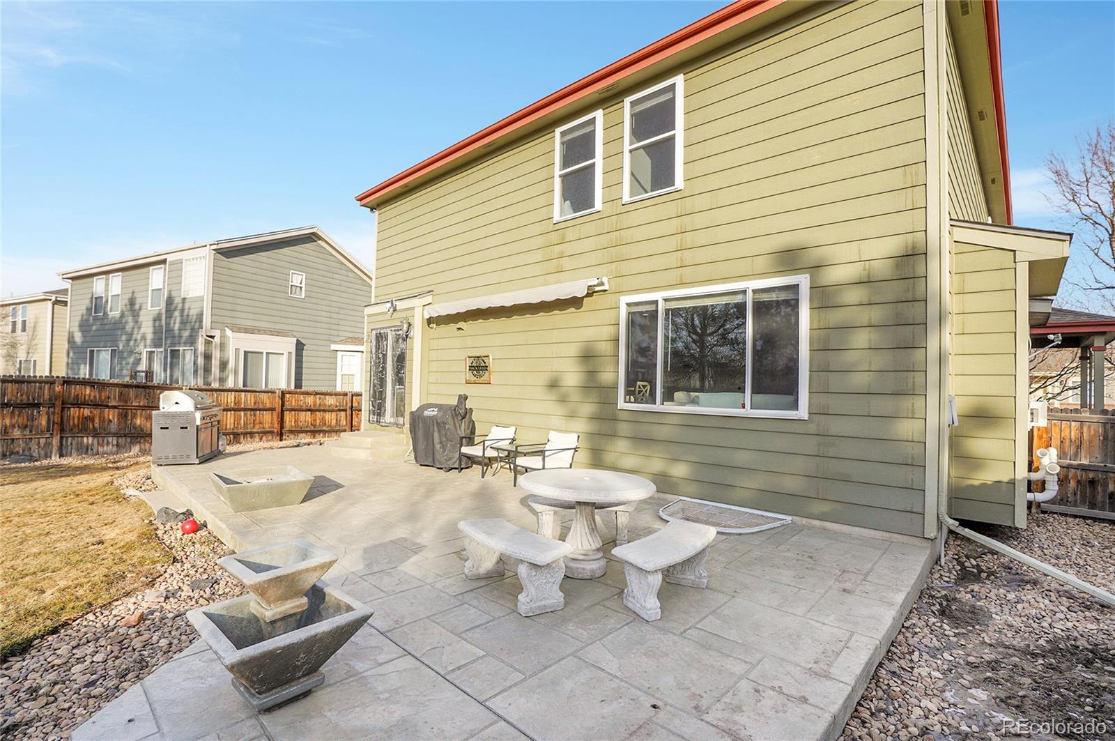 6348 Westview Circle Parker, CO 80134 - Photo 27 of 27 a view of a patio with dining table and chairs with wooden floor