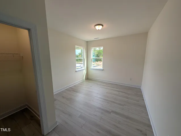 a kitchen with a sink a counter top space and living room area