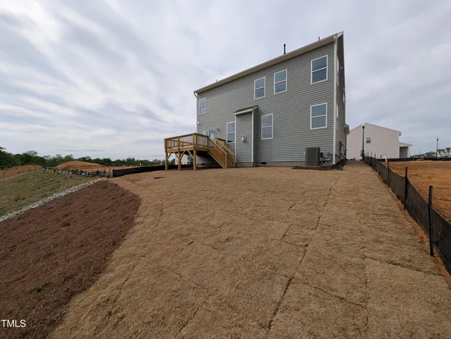a view of a house with wooden deck