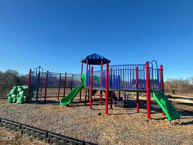 a view of a park with iron fence
