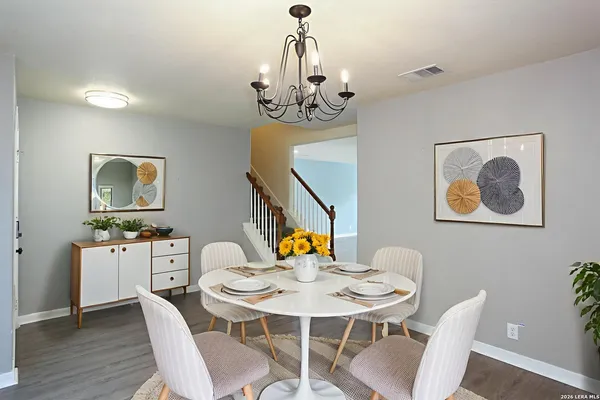 a view of a dining room with a table and chairs