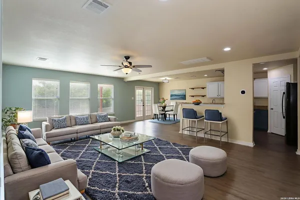 a living room with furniture and wooden floor