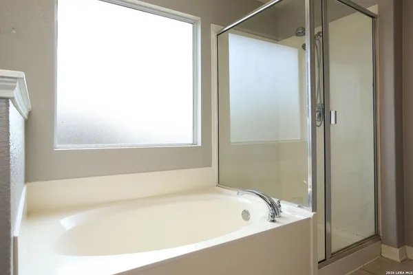 a bath tub sitting next to a white sink