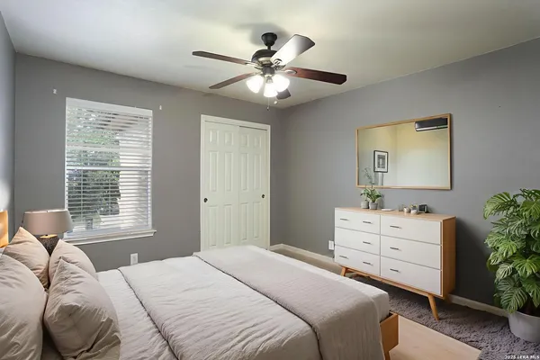 a bedroom with a bed and a window