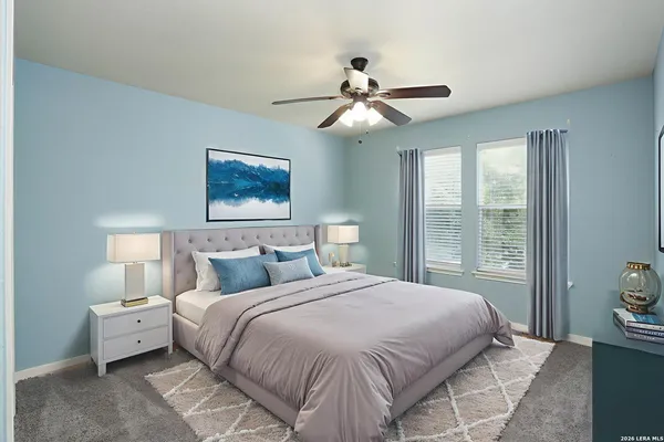 a bedroom with a large bed and a window