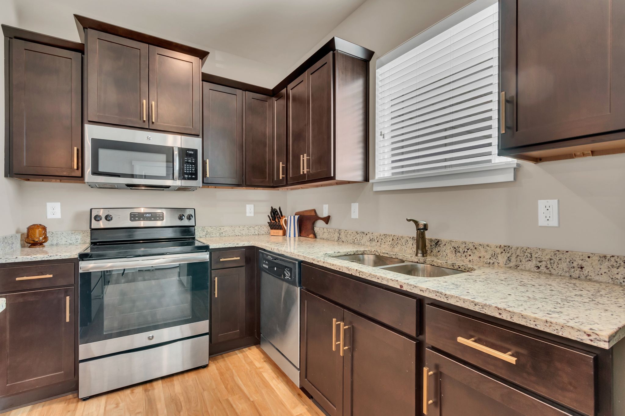 4004 Currant Court Spring Hill, TN 37174 - Photo 14 of 28 a kitchen with stainless steel appliances granite countertop a sink stove and microwave