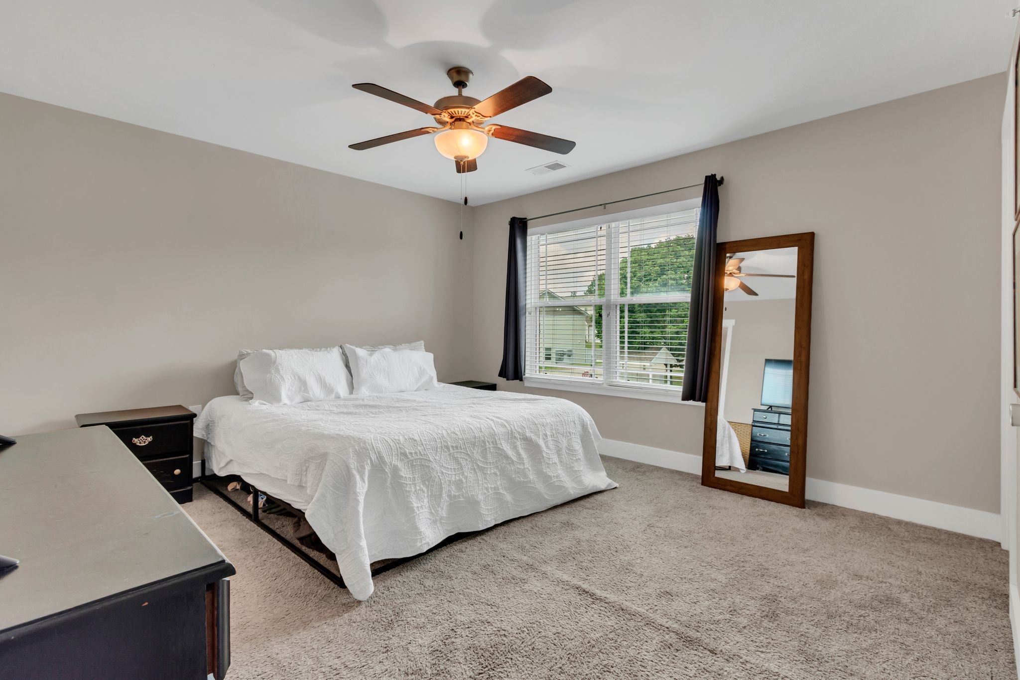 4004 Currant Court Spring Hill, TN 37174 - Photo 17 of 28 a spacious bedroom with a large bed and a chandelier