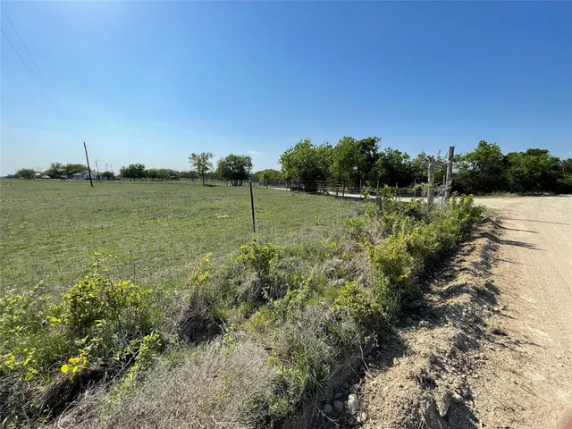an aerial view of a houses with a yard