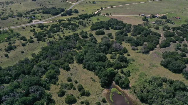 an aerial view of a houses with a yard