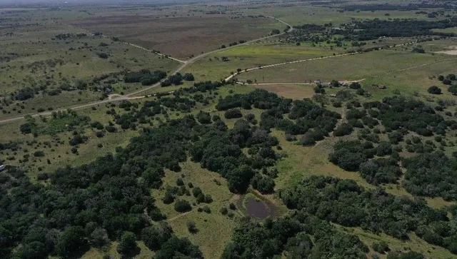 an aerial view of a houses with a yard