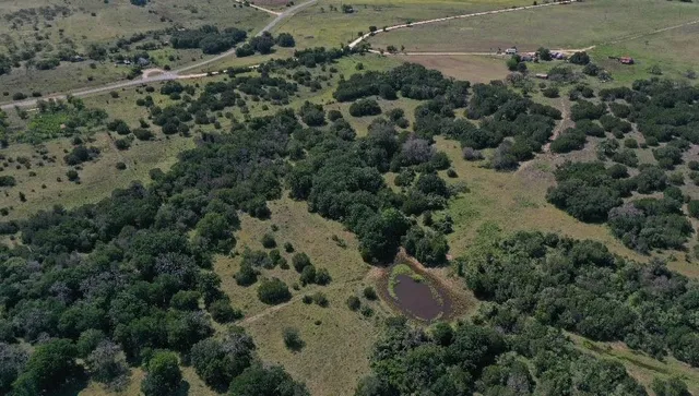 an aerial view of a houses with a yard