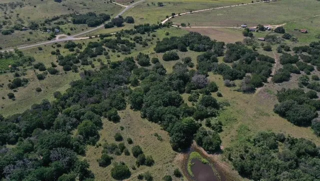an aerial view of a houses with a yard