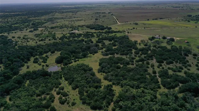 an aerial view of a houses with a yard