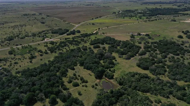 an aerial view of a houses with beach and ocean view
