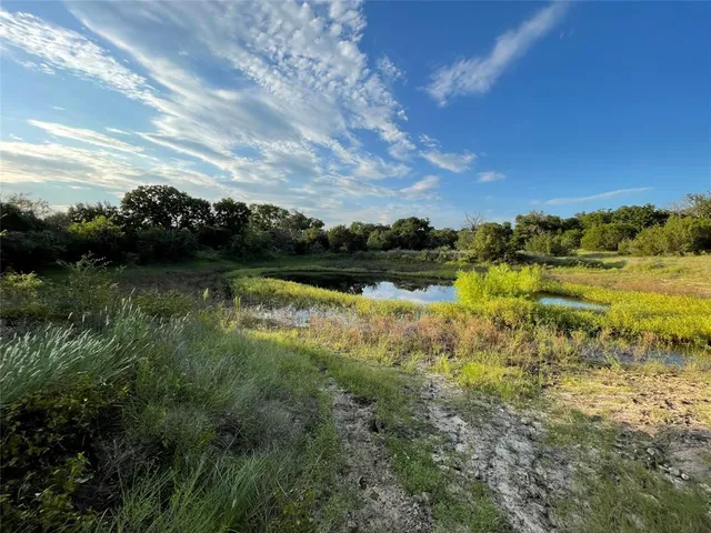 a view of a lake with houses in the back