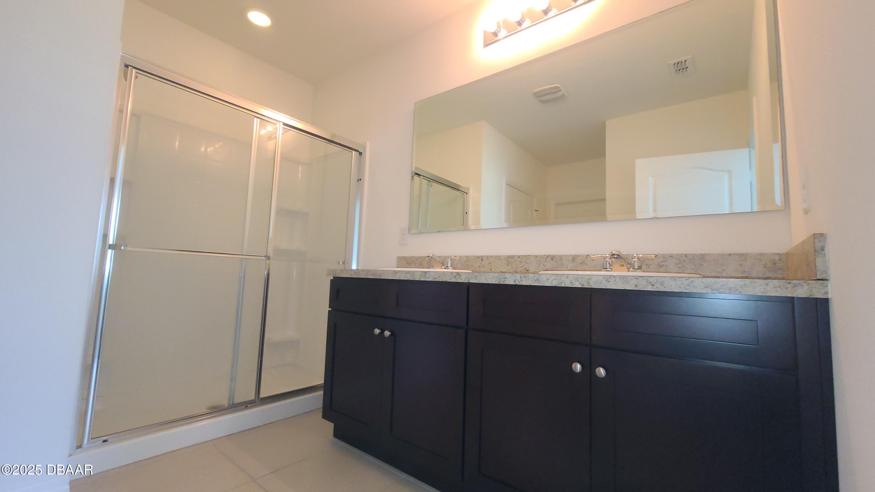 5296 Bear Corn Run Port Orange, FL 32128 - Photo 19 of 31 a bathroom with a granite countertop sink and a mirror