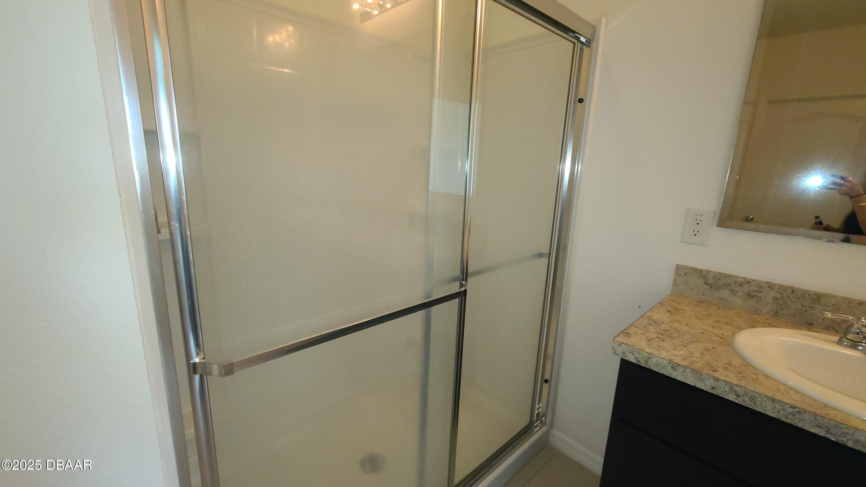 5296 Bear Corn Run Port Orange, FL 32128 - Photo 20 of 31 a bathroom with a granite countertop sink and shower