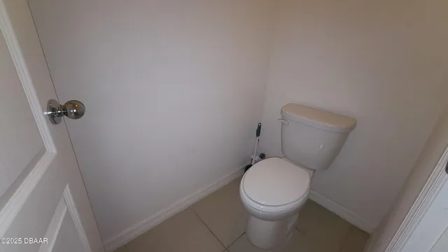 a white toilet sitting next to a sink