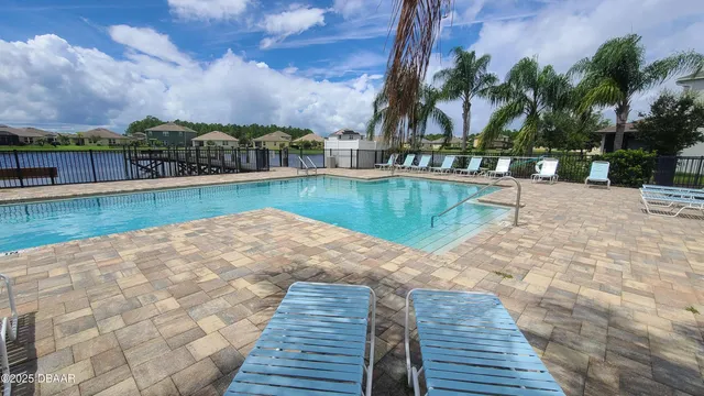 a view of swimming pool with outdoor seating and city view