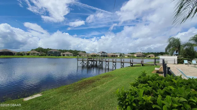 a view of a lake with houses in the back
