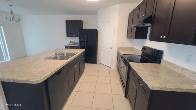 a kitchen with stainless steel appliances granite countertop a sink a stove and a microwave