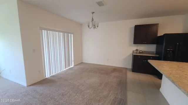 a kitchen with granite countertop a refrigerator and a sink