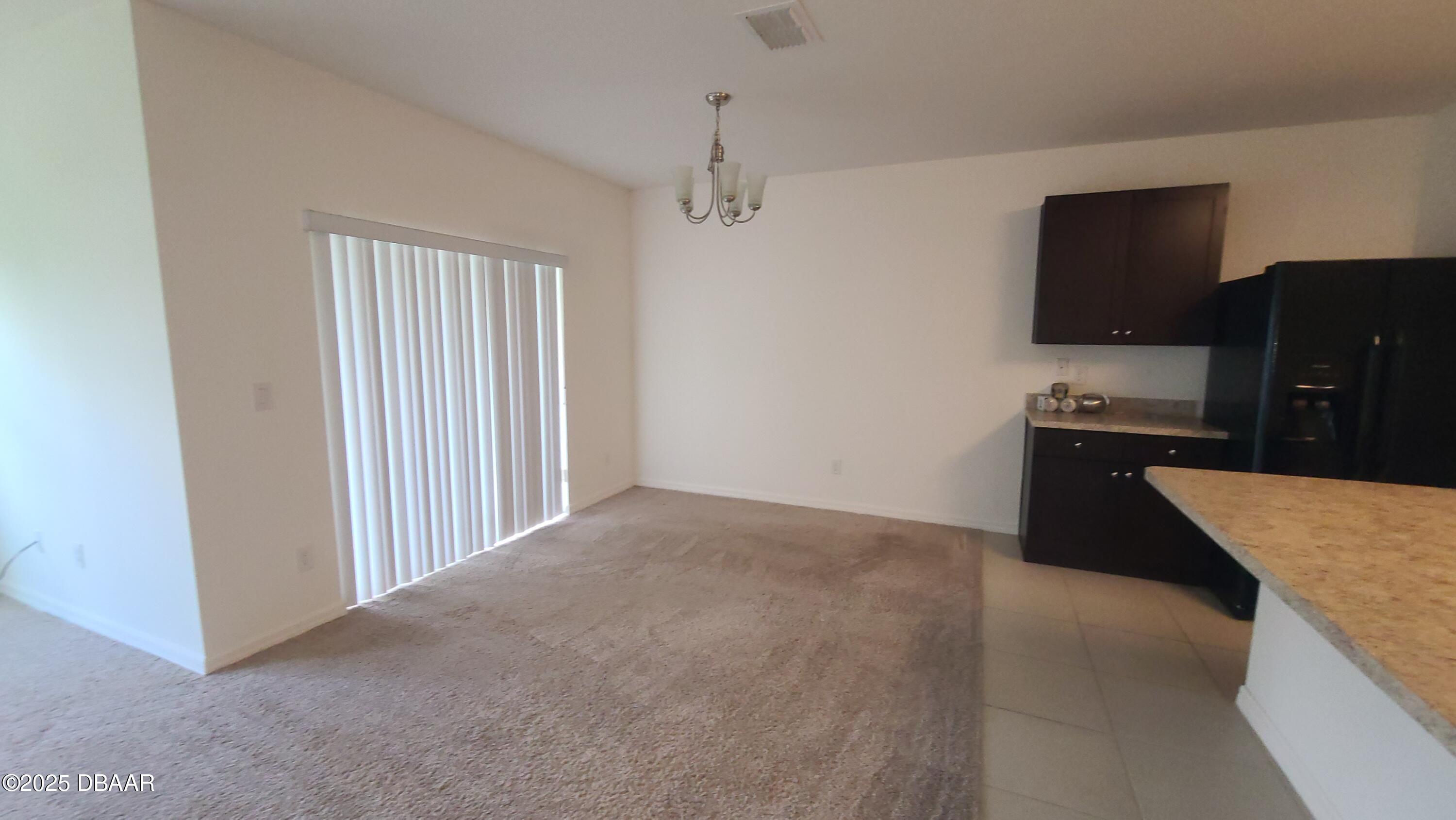5296 Bear Corn Run Port Orange, FL 32128 - Photo 8 of 31 a kitchen with granite countertop a refrigerator and a sink