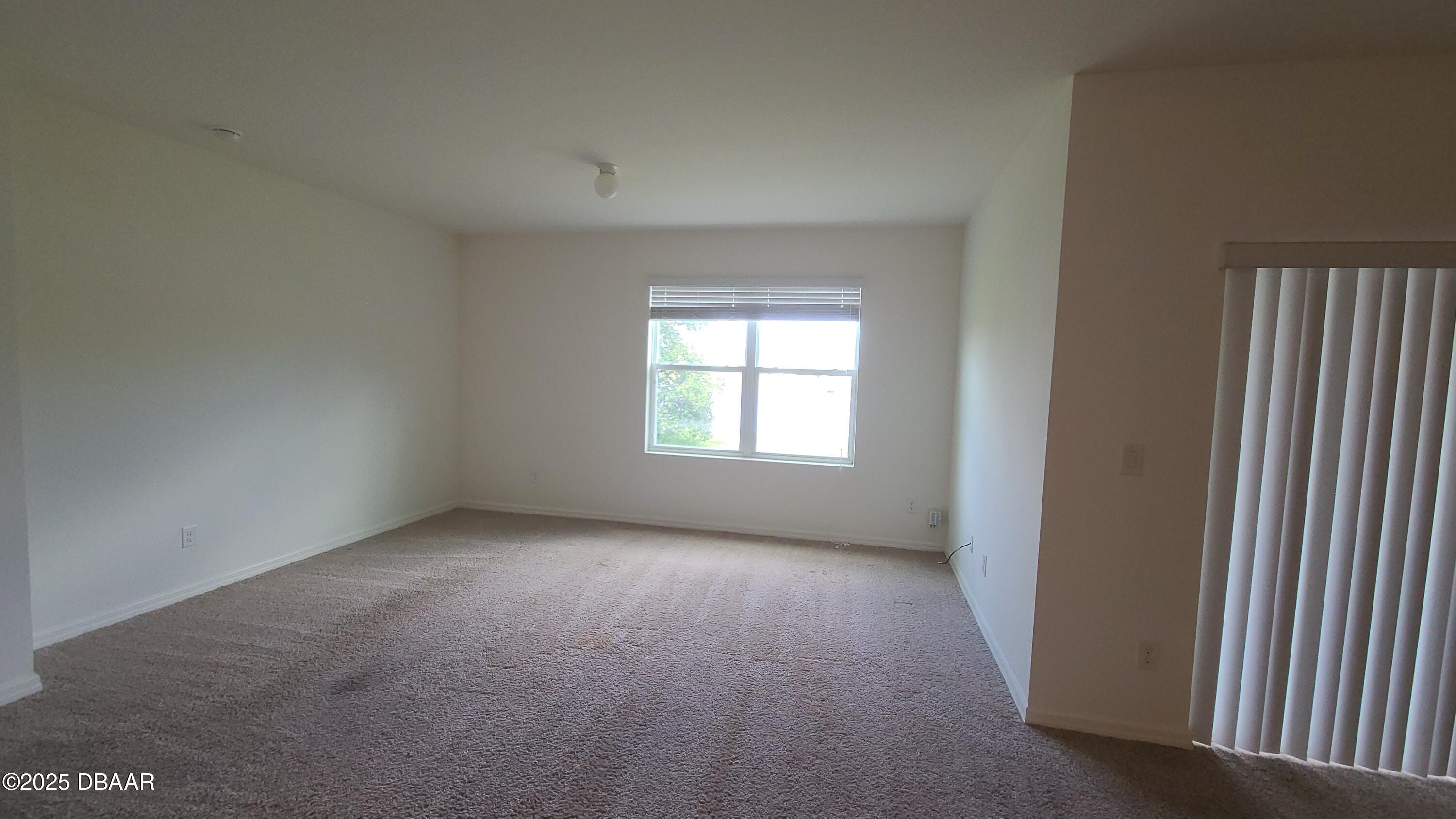5296 Bear Corn Run Port Orange, FL 32128 - Photo 10 of 31 an empty room with windows