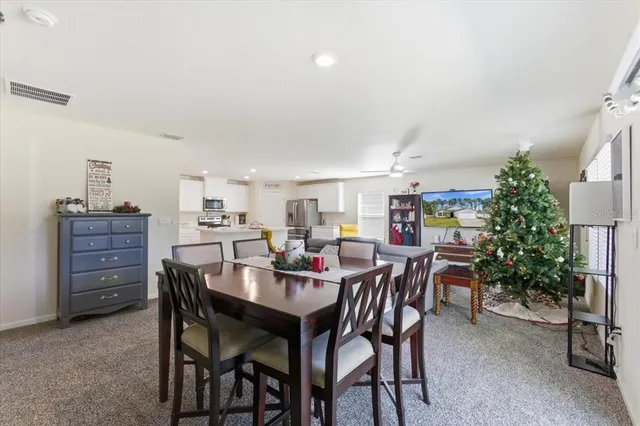 a kitchen that has a lot of cabinets a sink and appliances