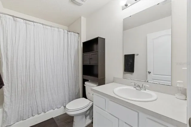 a view of a hallway with wooden floor and closet