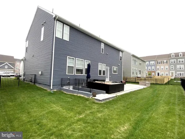 a view of a house with backyard sitting area and garden