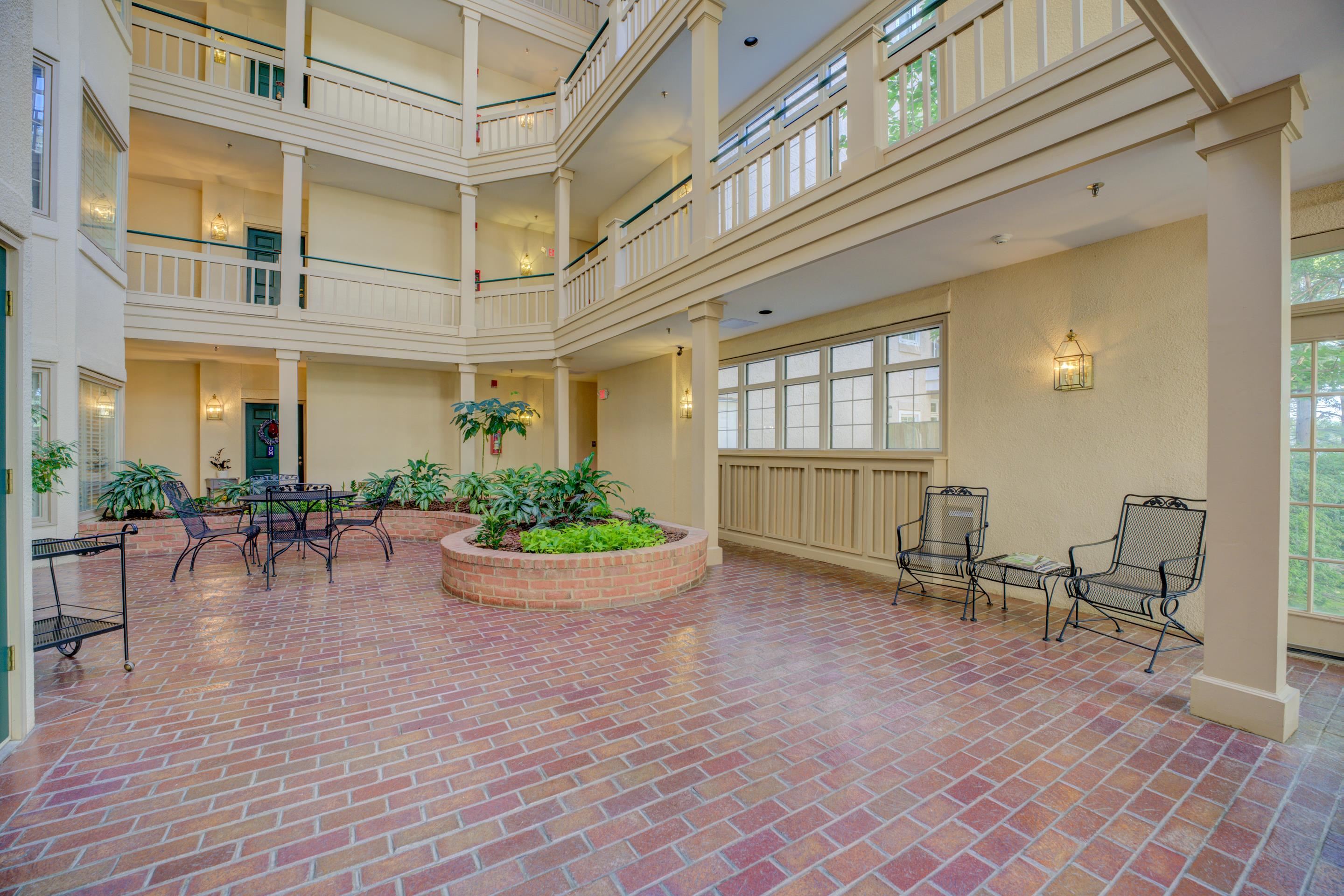 405 South Perkins Road, Unit 450 Memphis, TN 38117 - Photo 19 of 28 a view of a patio with a table and chairs and potted plants