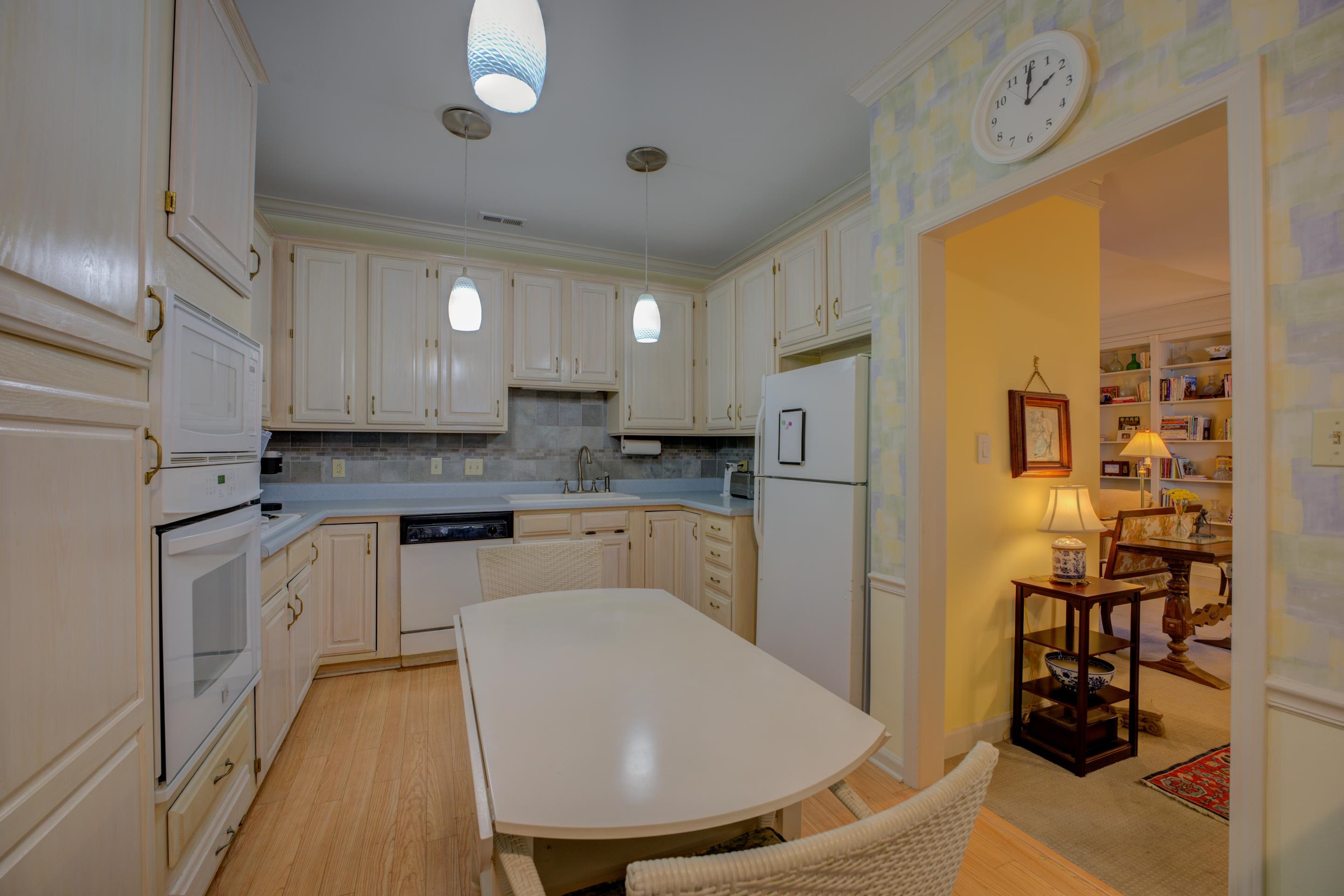 405 South Perkins Road, Unit 450 Memphis, TN 38117 - Photo 5 of 28 a kitchen with stainless steel appliances granite countertop a refrigerator a sink a stove and white cabinets with wooden floor