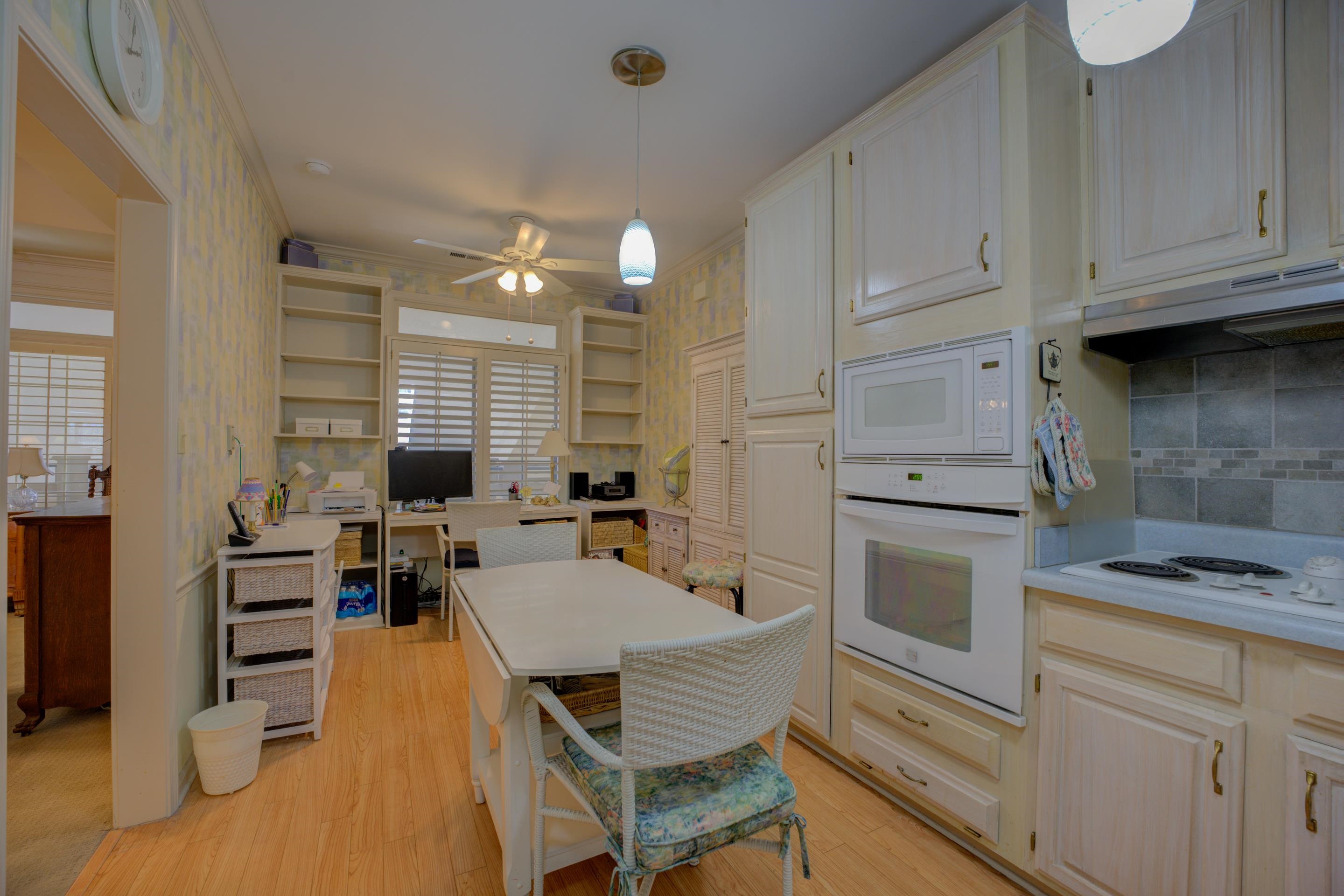 405 South Perkins Road, Unit 450 Memphis, TN 38117 - Photo 6 of 28 a kitchen with granite countertop a stove a sink dishwasher and white cabinets with wooden floor