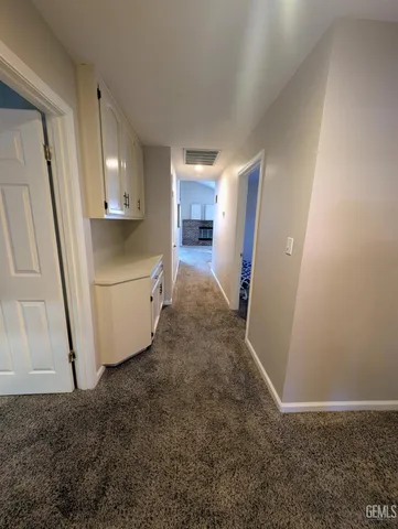 a view of a kitchen from the hallway