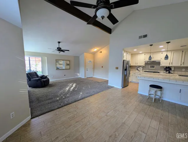 a living room with stainless steel appliances kitchen island granite countertop furniture and a kitchen view