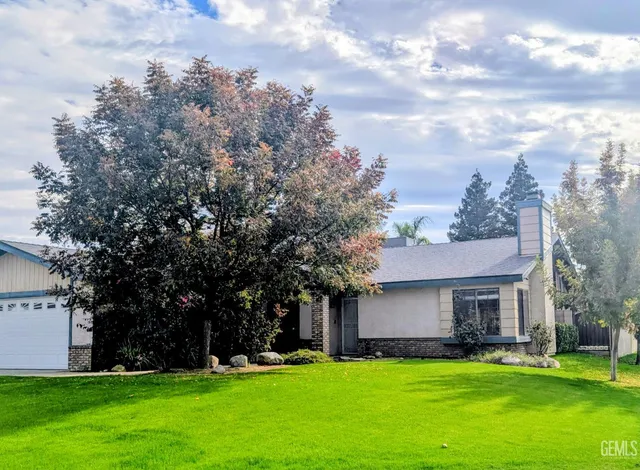a view of a house with a yard and sitting area