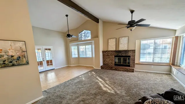 a view of an empty room with a fireplace and a window