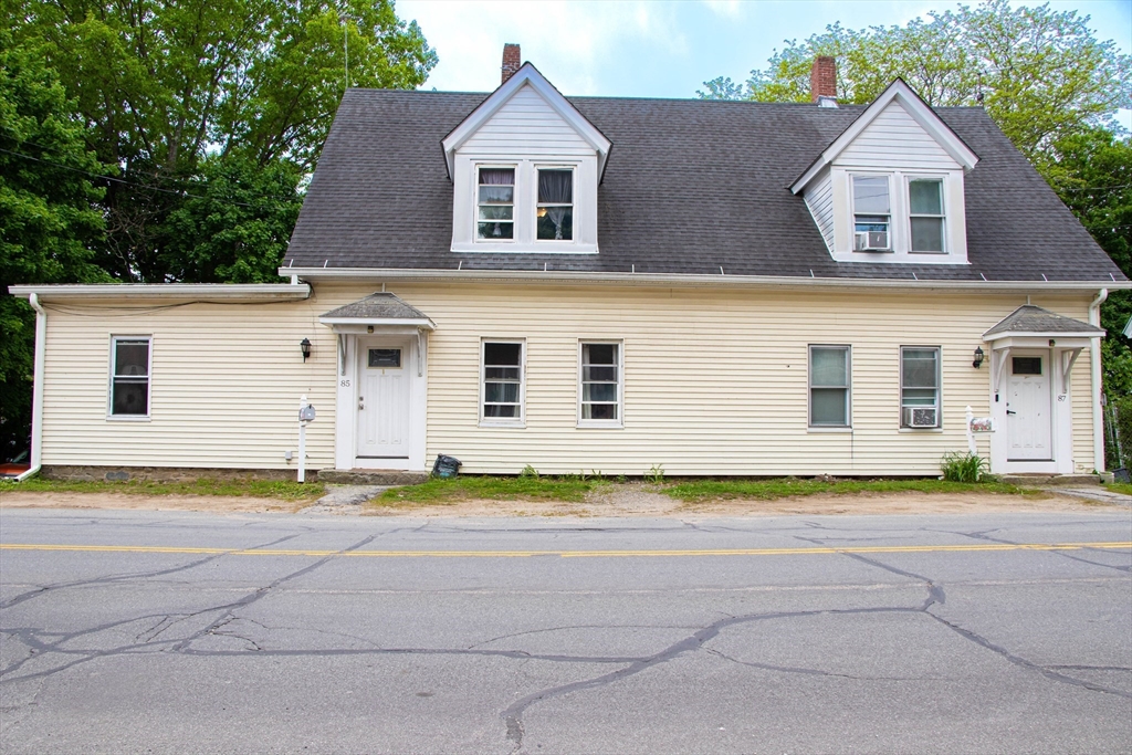 85-87 Slater Street Webster, MA 01570 - Photo 1 of 41 a front view of a house with a yard