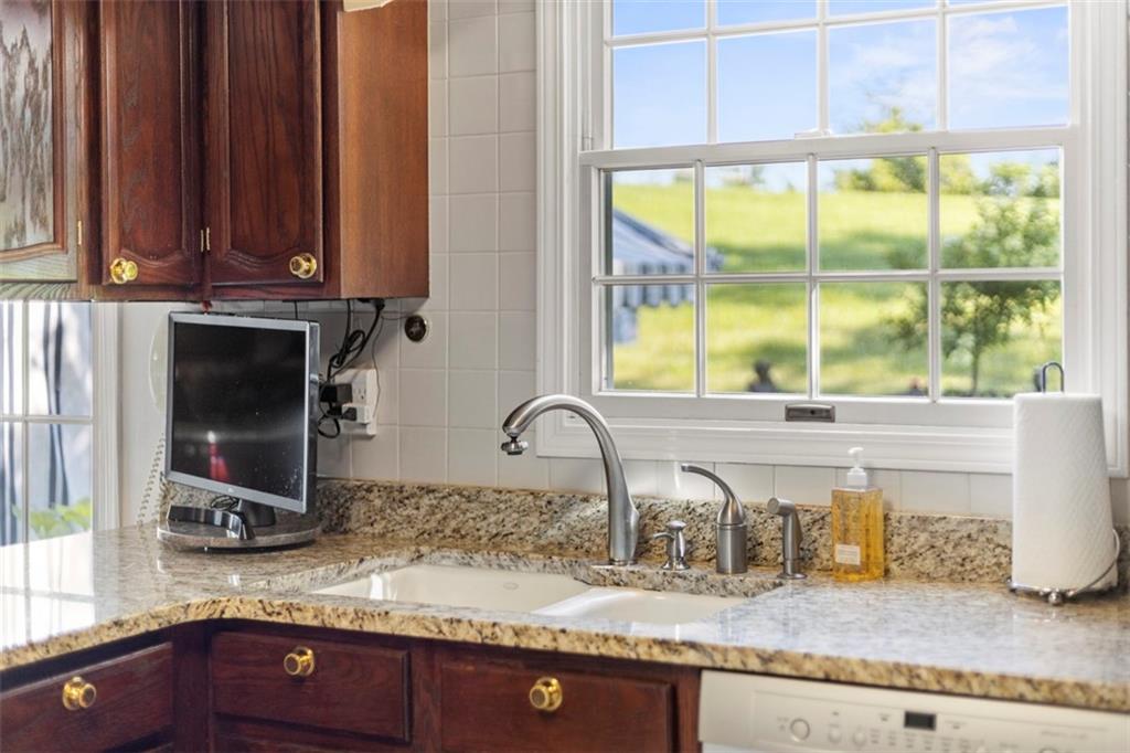 99 Walnut Drive McKees Rocks, PA 15136 - Photo 17 of 50 a kitchen with granite countertop a sink and a window