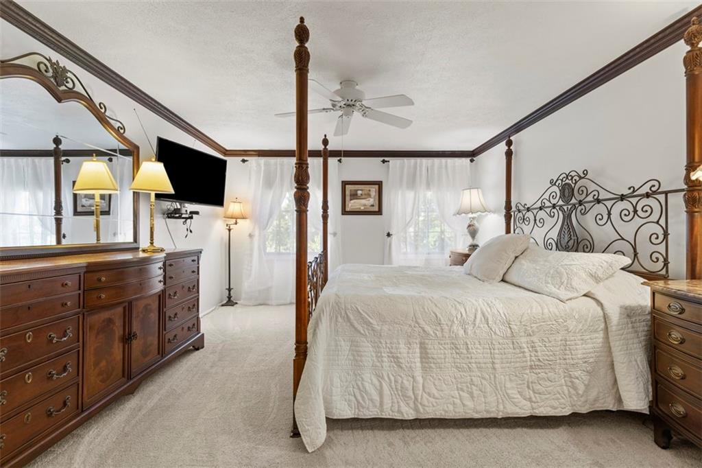 99 Walnut Drive McKees Rocks, PA 15136 - Photo 23 of 50 a spacious bedroom with a bed a mirror on dresser and a large window