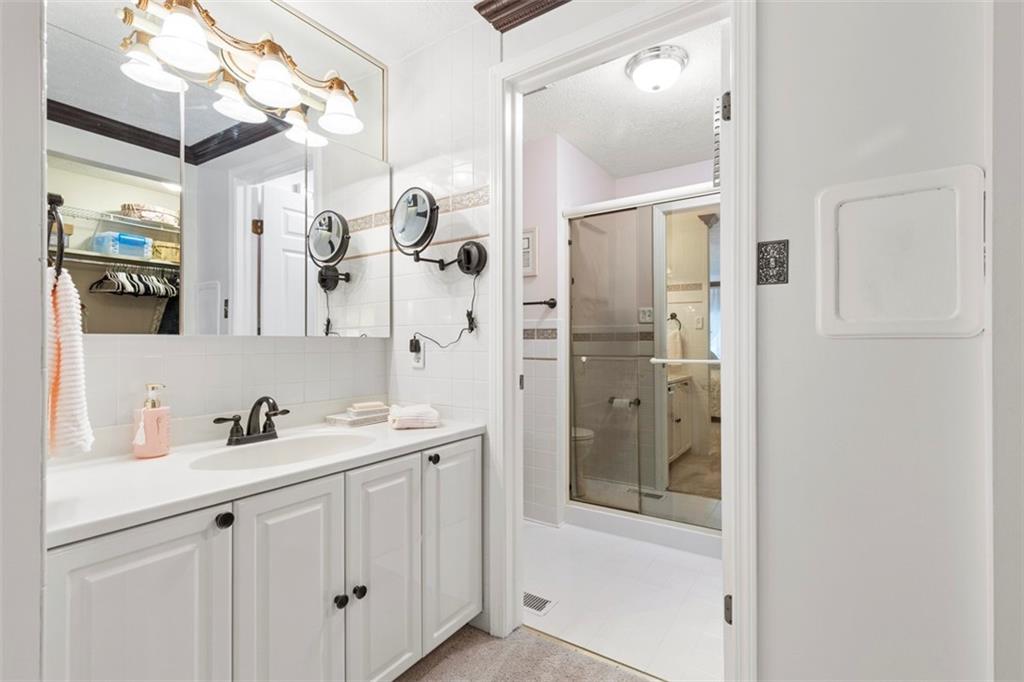 99 Walnut Drive McKees Rocks, PA 15136 - Photo 26 of 50 a bathroom with a shower sink and mirror