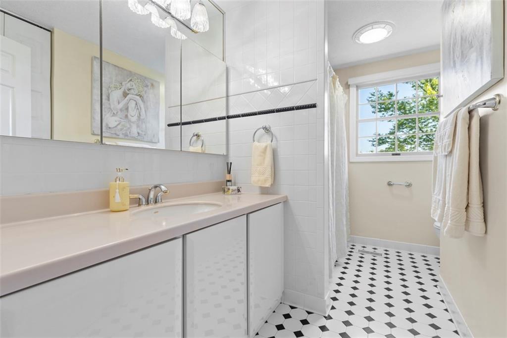 99 Walnut Drive McKees Rocks, PA 15136 - Photo 31 of 50 a bathroom with a sink a mirror and shower