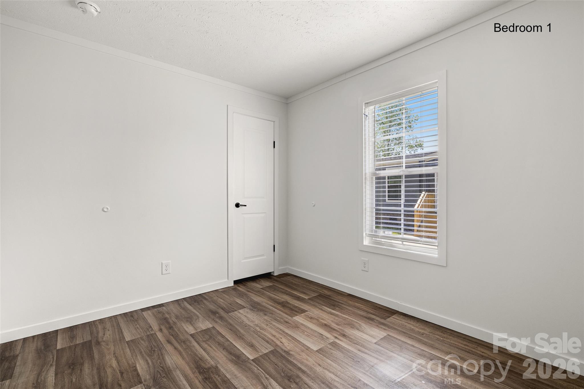 1109 Marion Street Lancaster, SC 29720 - Photo 19 of 44 a view of empty room with wooden floor and fan