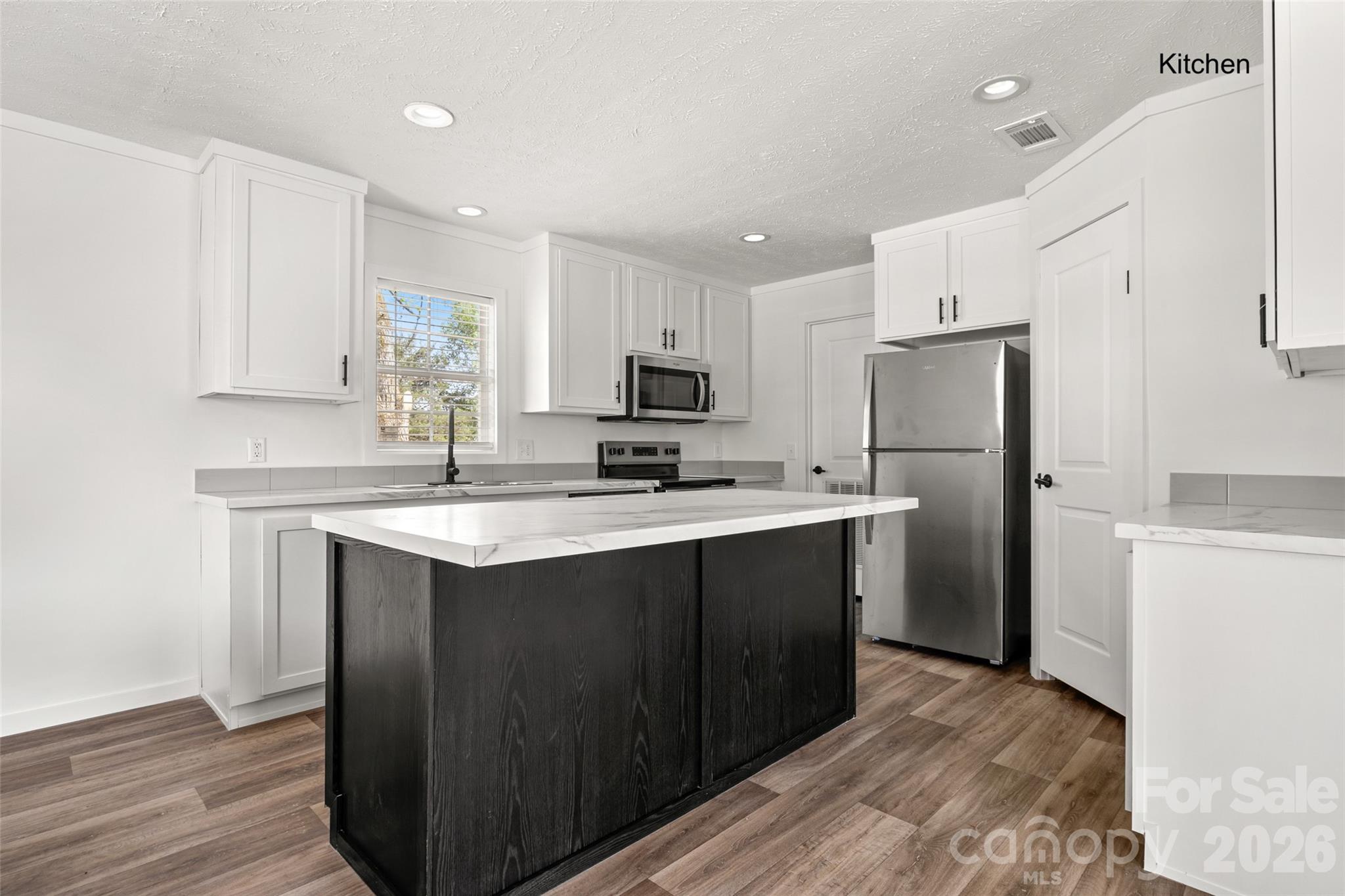 1109 Marion Street Lancaster, SC 29720 - Photo 4 of 44 a kitchen with refrigerator cabinets and wooden floor