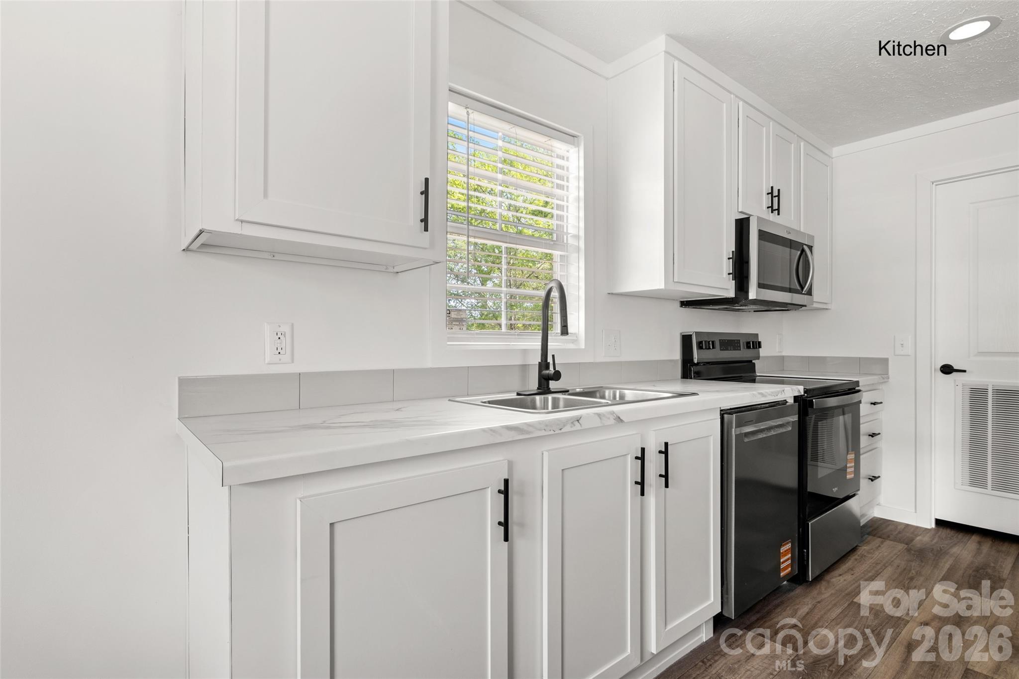 1109 Marion Street Lancaster, SC 29720 - Photo 5 of 44 a kitchen with stainless steel appliances granite countertop a sink dishwasher a stove and a microwave oven with cabinets